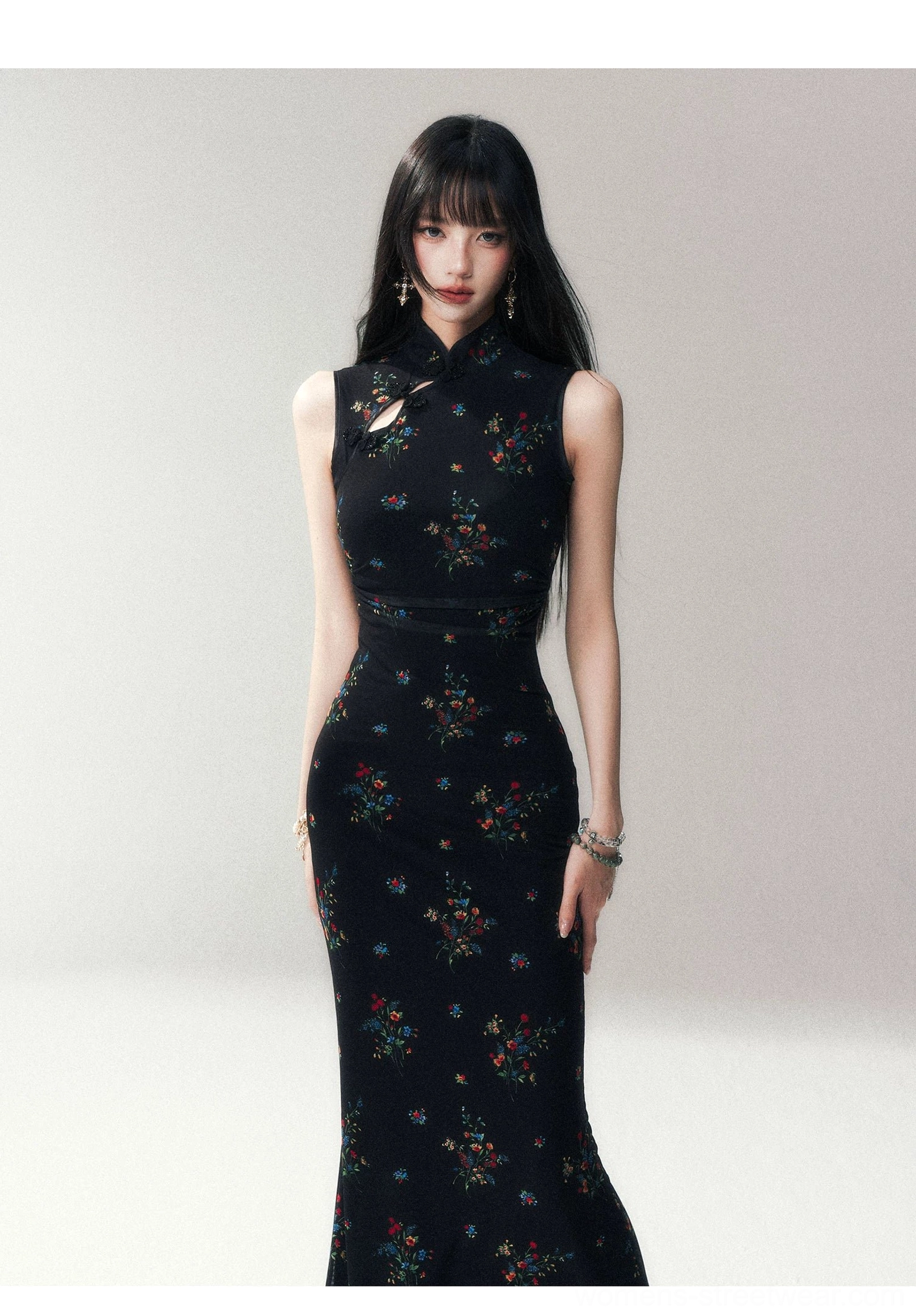 Three-quarter front view of a black floral cheongsam maxi dress with fitted waist, floor-length hem, Mandarin collar, keyhole detail, and delicate floral print