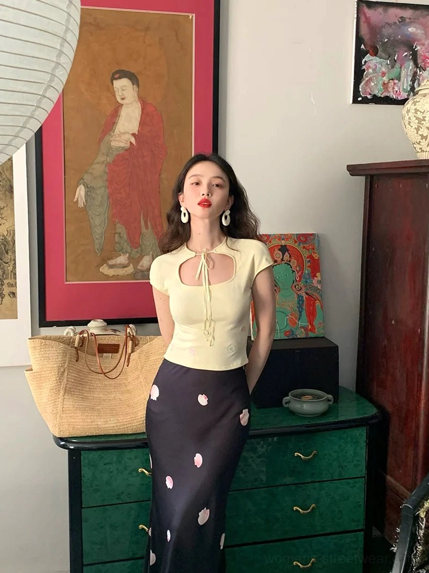 Front full-body outfit featuring a black floral maxi skirt with pink blossoms and a matching cropped top