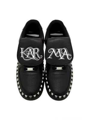Pair of black foldover tongue chunky leather sneakers with split gothic lettering, silver studded midsoles and metal lace lock hardware