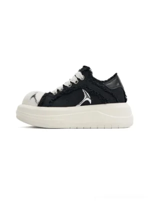 Black frayed canvas platform skate sneakers with white rubber toe caps and thick platform soles shown from the left side