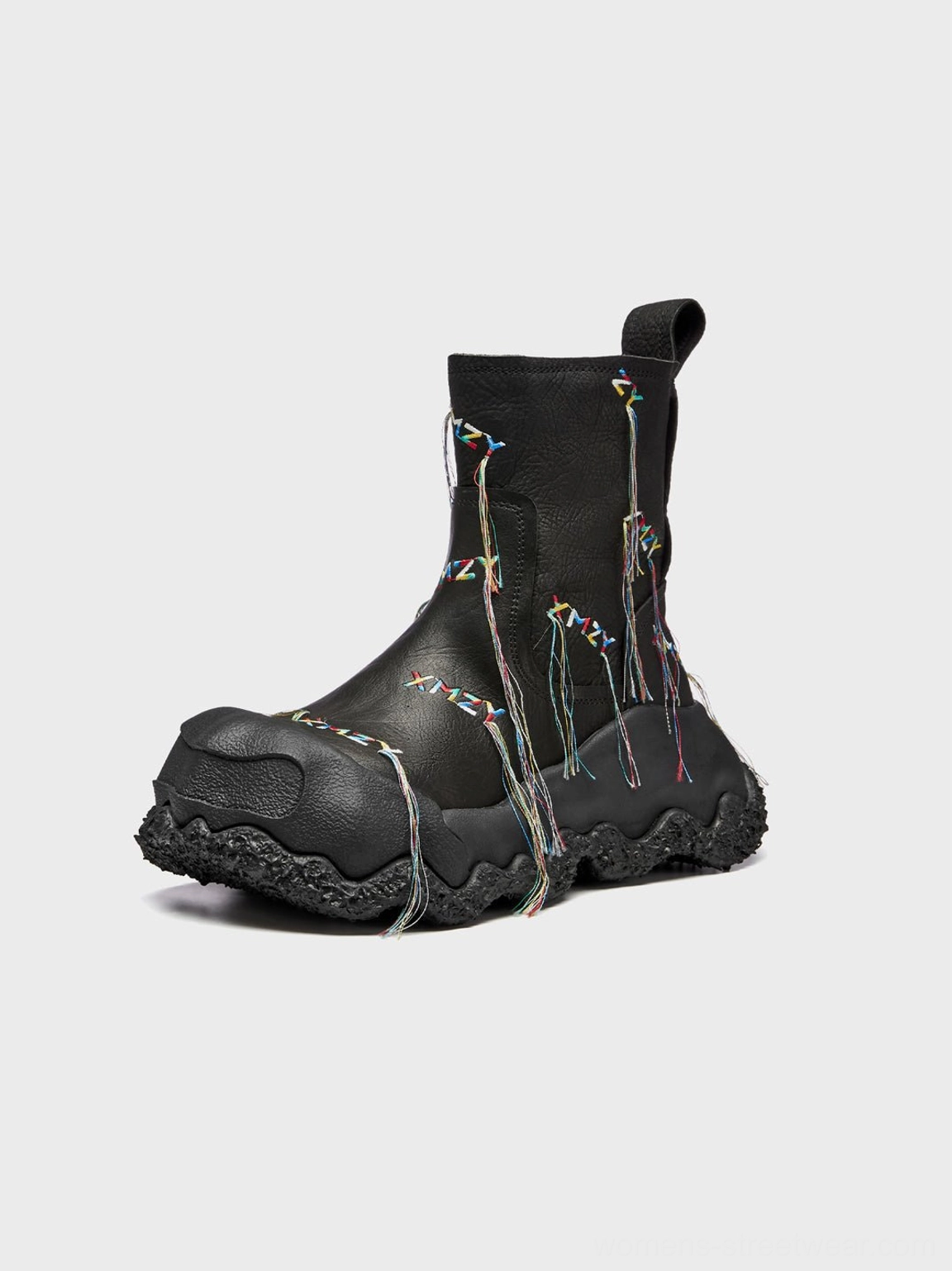Right side studio view of black western ankle boots with colorful hanging fringe tassels and sculptural chunky treaded outsole