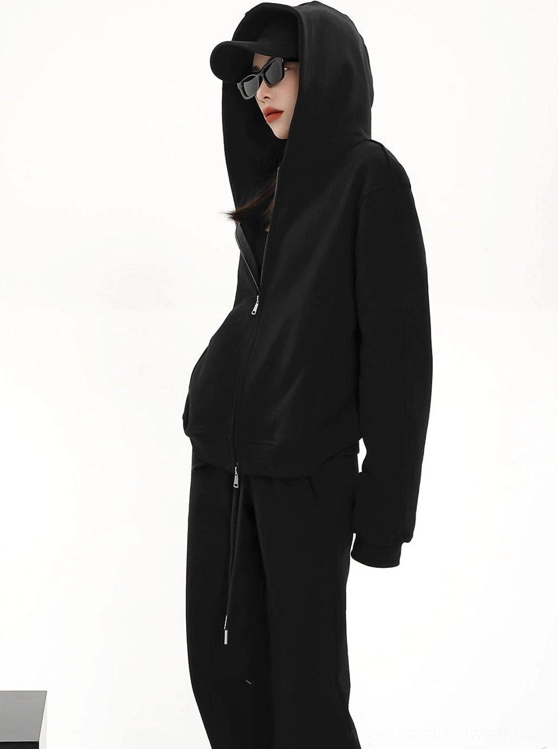 Black women's full zip hoodie jacket worn with the hood up for a clean oversized Seoul streetwear look