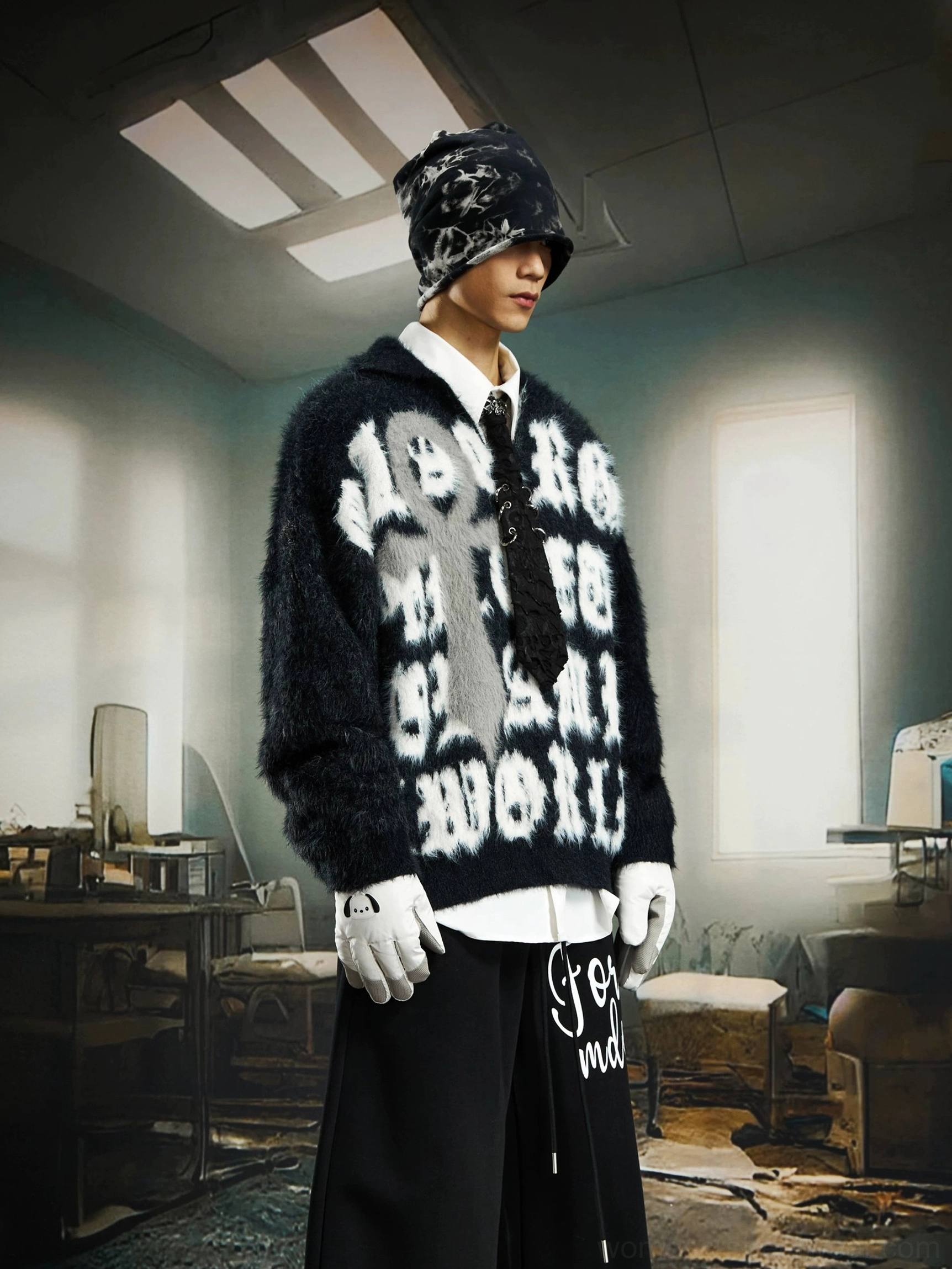 Side view of a black fuzzy gothic cross sweater styled with wide leg black pants, beanie, and alternative streetwear accessories