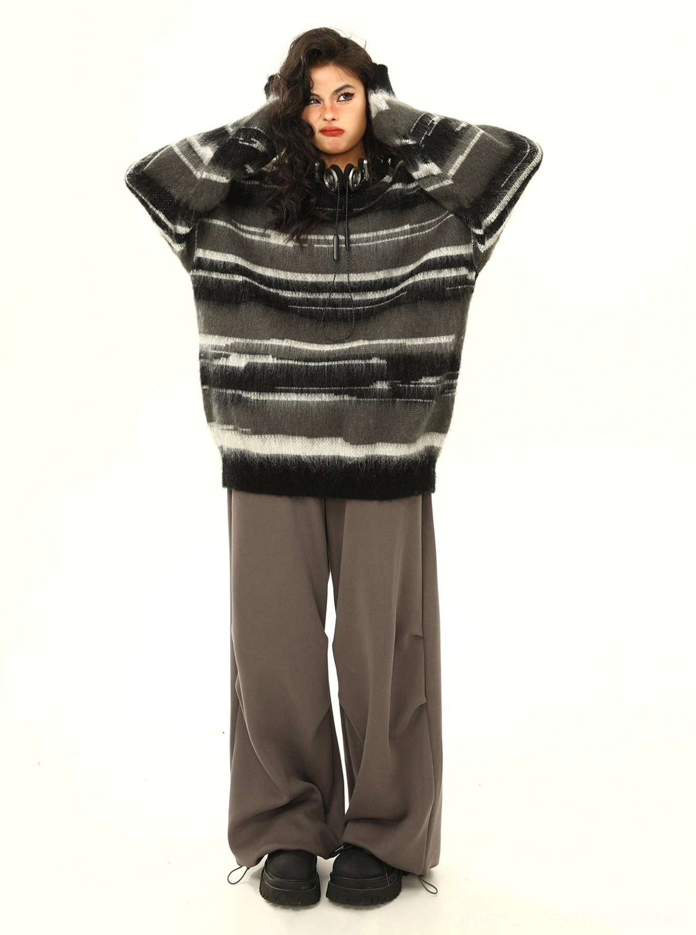 Black fuzzy striped oversized hooded knit sweater full back view showing drawstring hood and ribbed hem