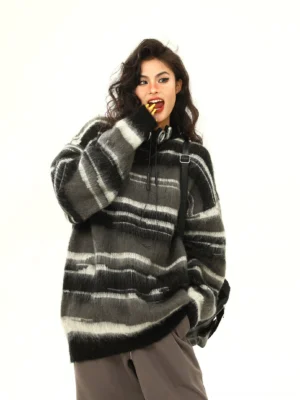 Black fuzzy striped oversized hooded knit sweater three quarter front view with relaxed dropped shoulders