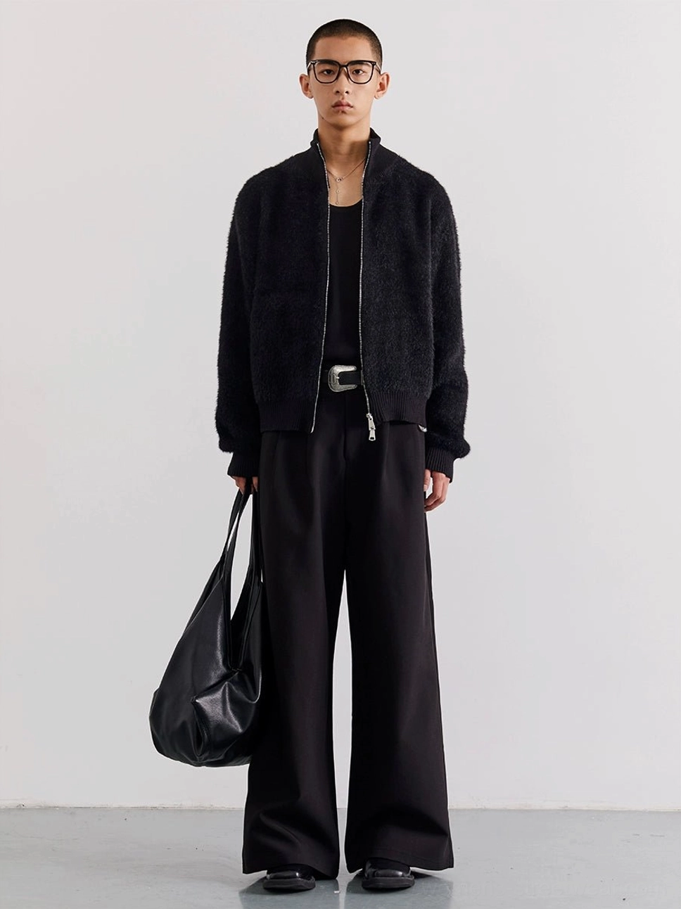 Black fuzzy zip-up fleece cardigan worn in a full-body front view for minimalist Seoul streetwear styling