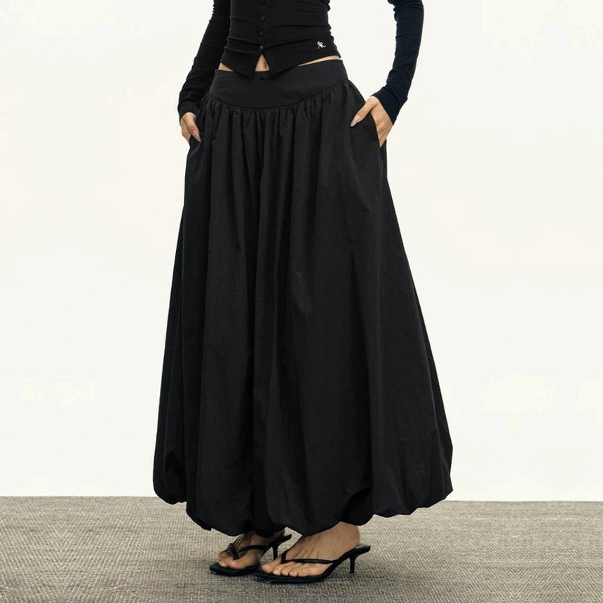 Black gathered high waisted bubble maxi skirt detail showing side pocket and puffed maxi hem