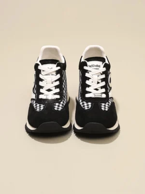 Front view of black gingham platform sneakers showing the rounded toe white lace-up closure and elevated low-top streetwear silhouette