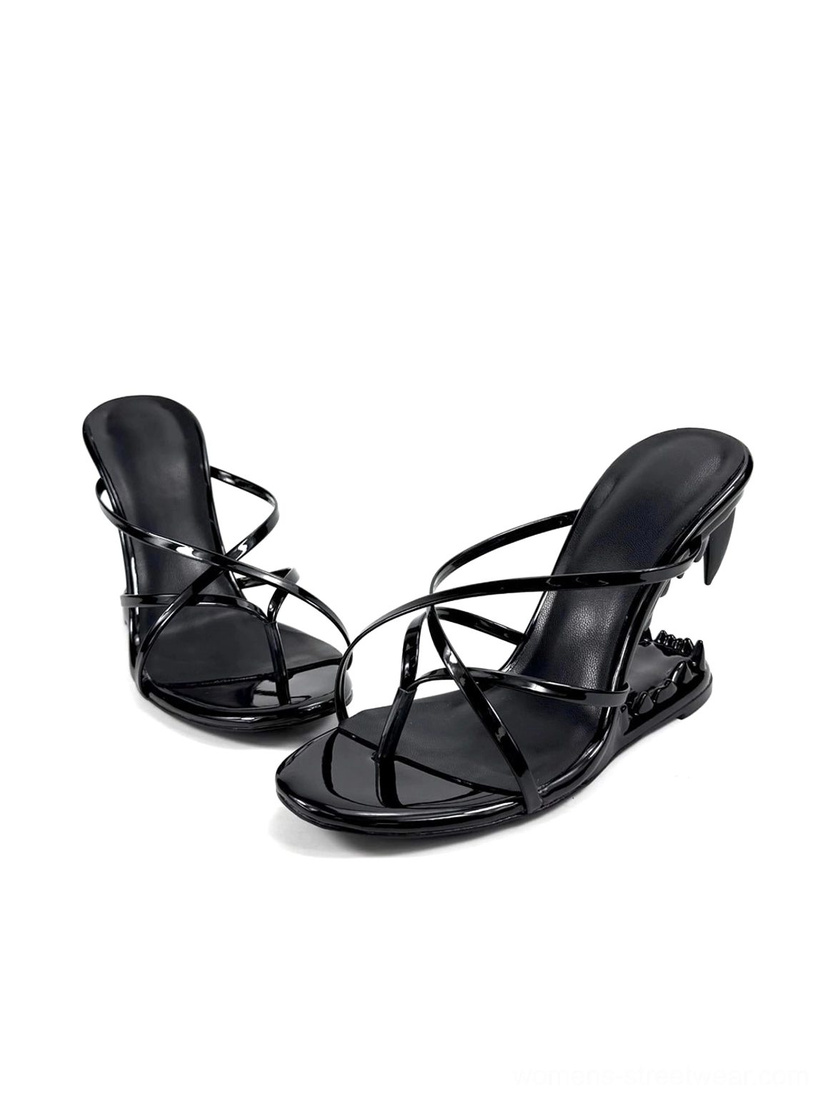 Front-side studio product view of black shiny mule sandals with crossover toe straps and open square toes