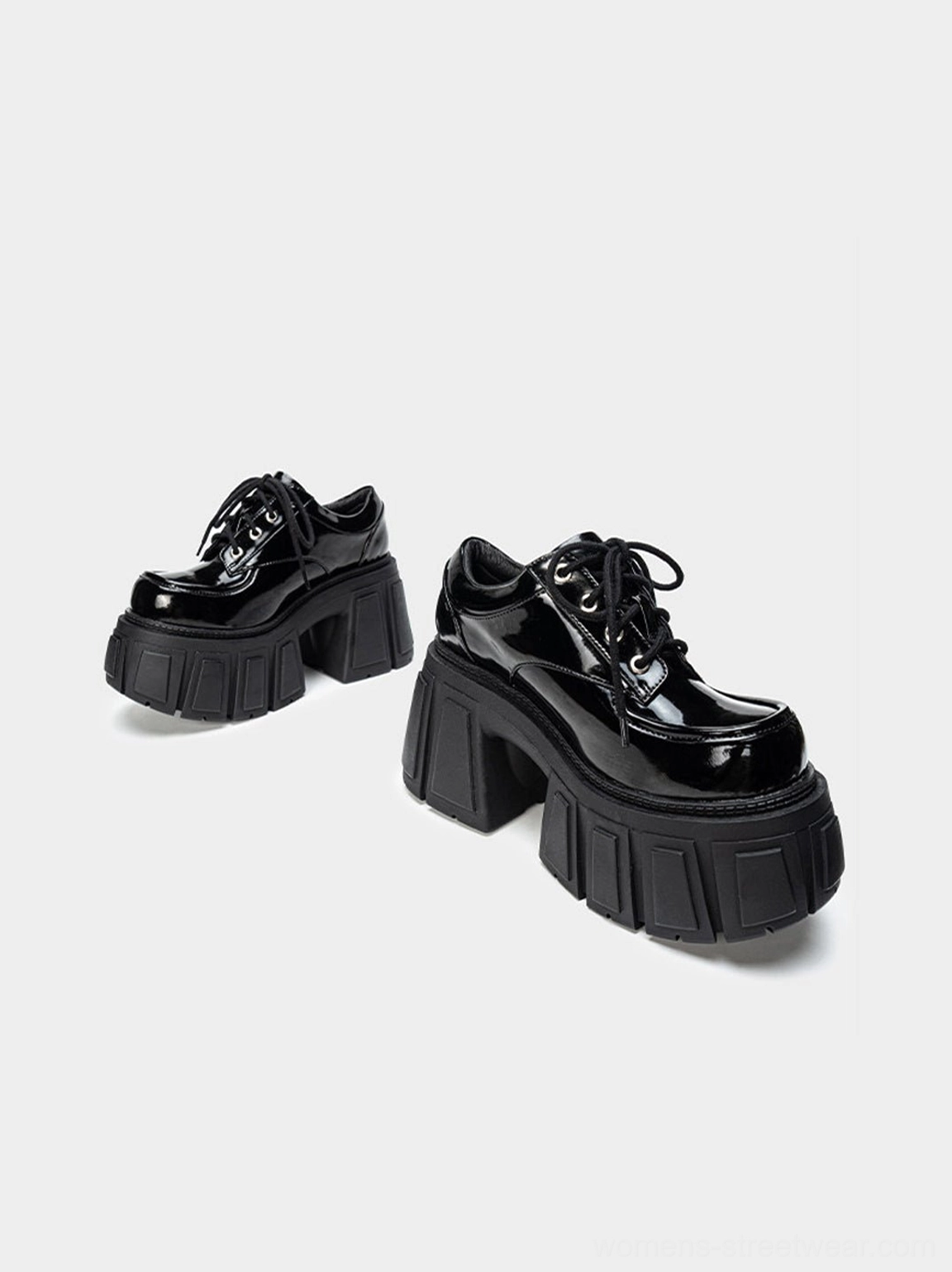 Black glossy platform derby heels with architectural block heel and heavy grooved sole for avant-garde streetwear