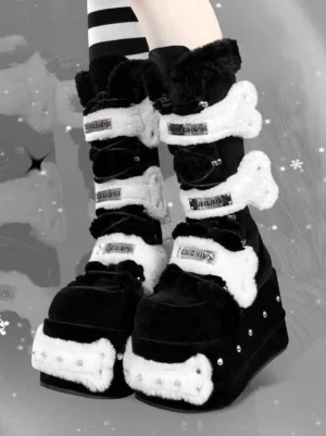 Pair of black goth platform fur boots worn with striped thigh-high socks and buckle strap details in a snowy fashion scene