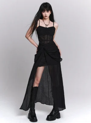 Black gothic asymmetrical slip dress with sheer corset bodice, spaghetti straps, twisted ruched waist, and high-low sheer skirt styled with combat boots