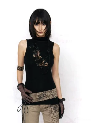 Black gothic floral lace cutout turtleneck knit tank top styled with printed trousers in a full body streetwear outfit