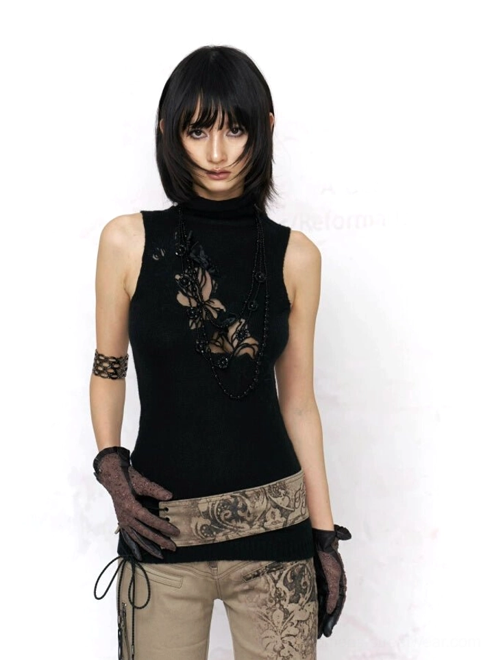 Black gothic floral lace cutout turtleneck knit tank top styled with printed trousers in a full body streetwear outfit