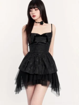 Black gothic Lolita mini dress with sweetheart neckline, spaghetti straps, velvet bow, fitted bodice, and layered tulle skirt styled with white knee-high socks
