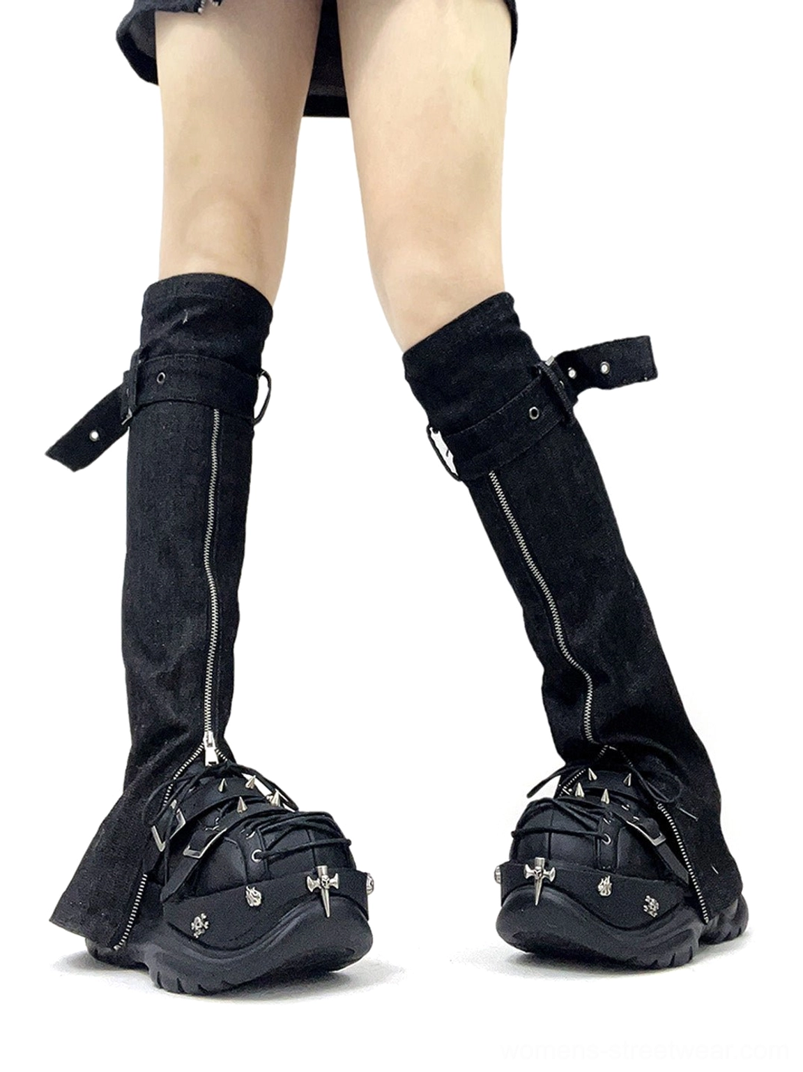 Side view of black gothic platform sneakers with denim leg sleeves, buckle decorations, cross toe charms, lace-up front, and thick platform sole