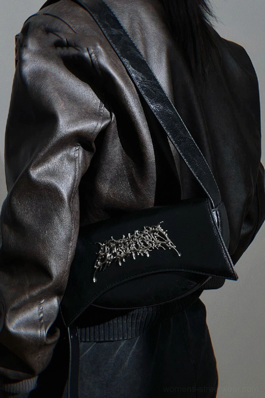 Close-up of silver thorn metal logo on black matte PU leather gothic crossbody shoulder bag