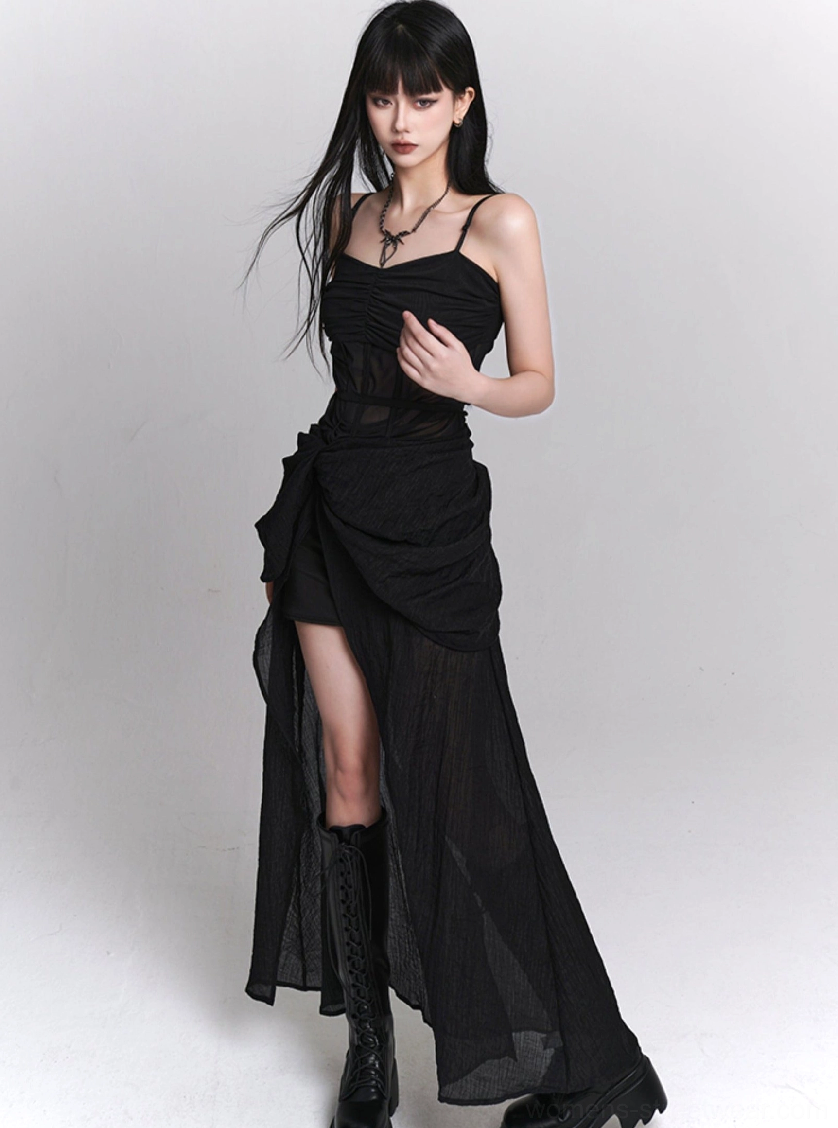 Side profile of black gothic slip dress with sheer corset waist, ruched side skirt, floor-length sheer overlay, and dramatic side split