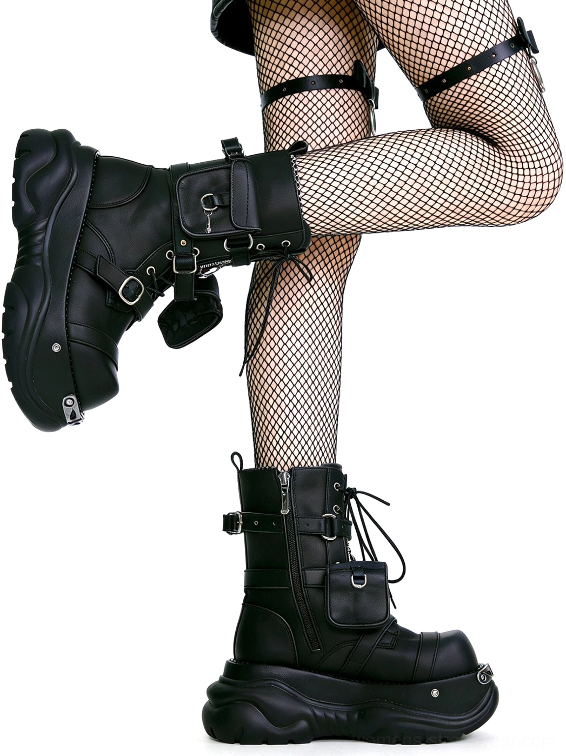 Model wearing black gothic utility pouch chunky platform combat boots with fishnet stockings and thigh harness straps in a dark streetwear outfit