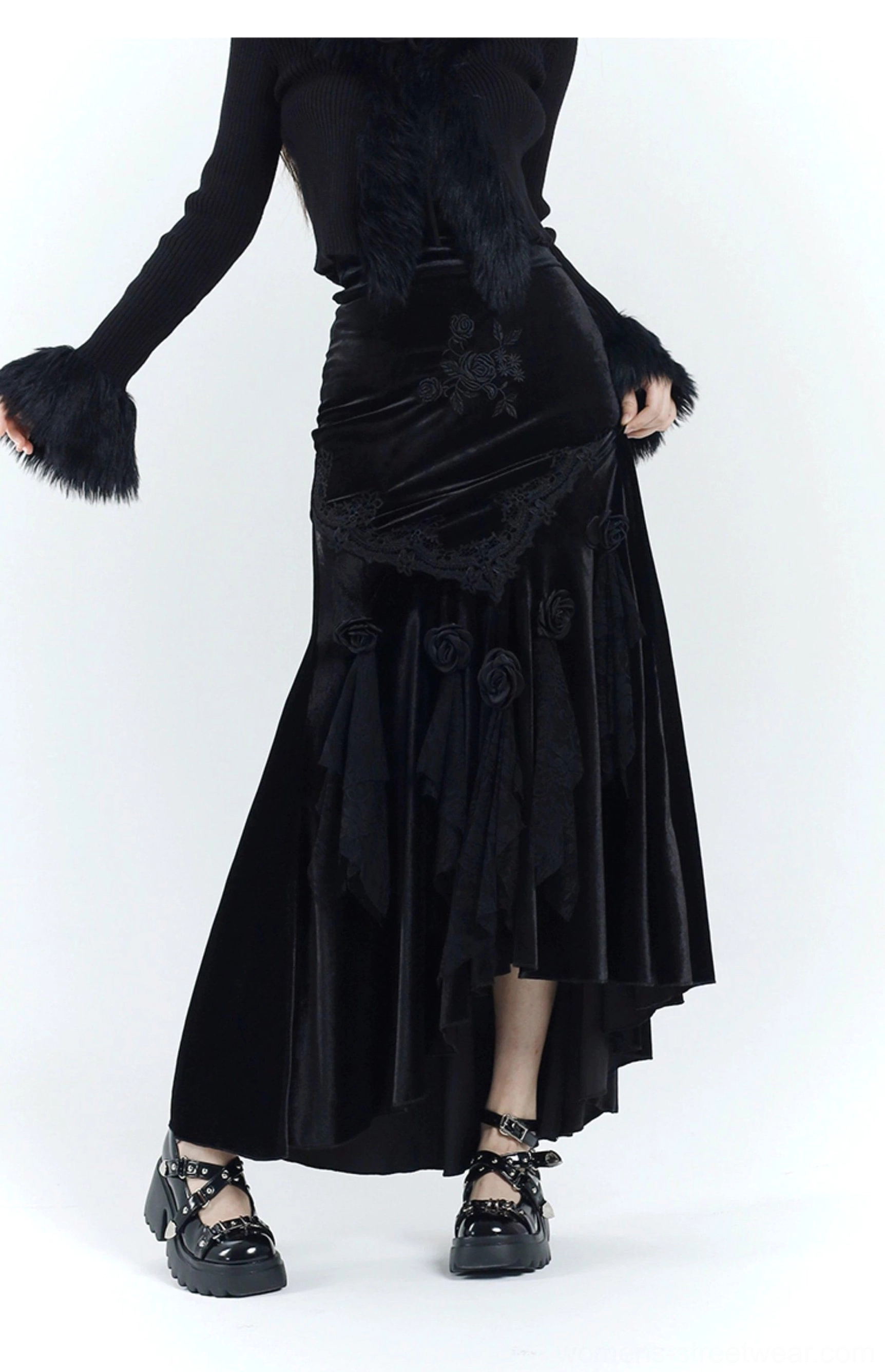 Side view of a black gothic velvet fishtail dress with rose and lace decorations, asymmetric high-low hem, and platform sandals