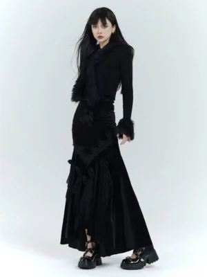 Full body view of a black gothic velvet fishtail dress with floral embroidery, lace appliques, faux fur trim, and platform shoes
