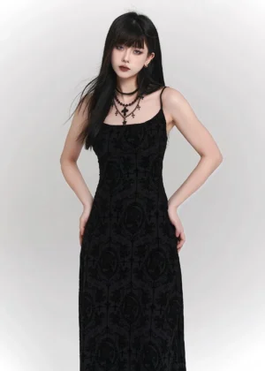 Front view of a black gothic velvet maxi dress with square neckline, fitted bodice, damask cross print, layered choker styling, and floor-length silhouette