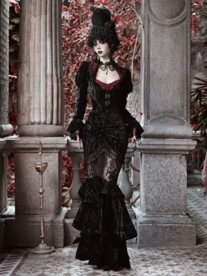 Gothic black velvet mermaid skirt styled in a dramatic corset outfit with sheer ruffled details and a layered fishtail hem against a classical stone colonnade