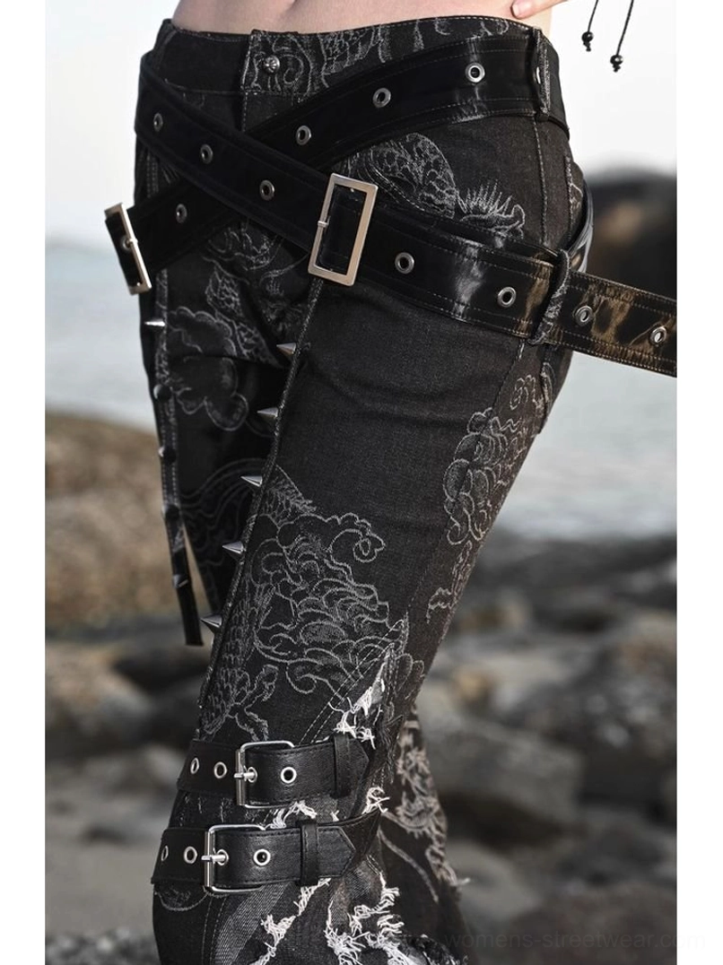 Black gothic western dragon print flare jeans with dramatic flared legs, distressed denim details, buckle straps, and alternative streetwear styling