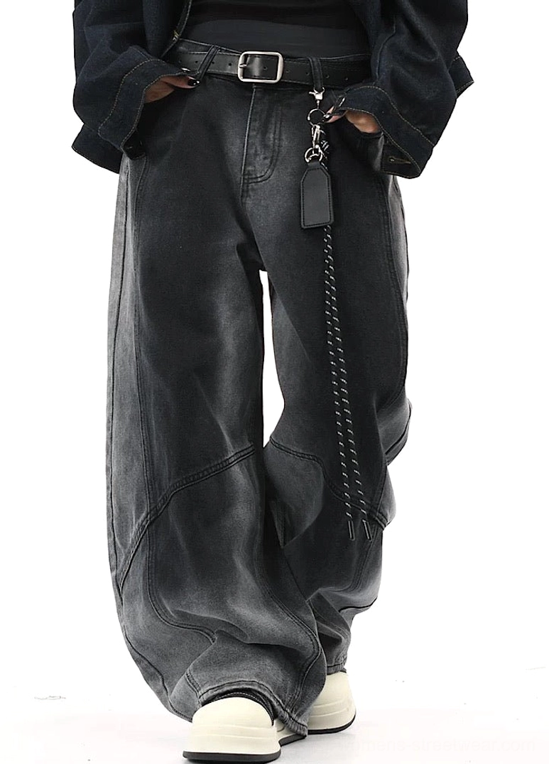 Front three-quarter view of black gradient washed wide-leg pants with high-waisted cut, curved tailored seams, cropped top, black jacket, and sneakers