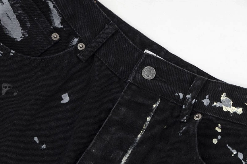 Close-up of waistband button belt loops and graffiti print on black Y2K wide-leg streetwear jeans for women