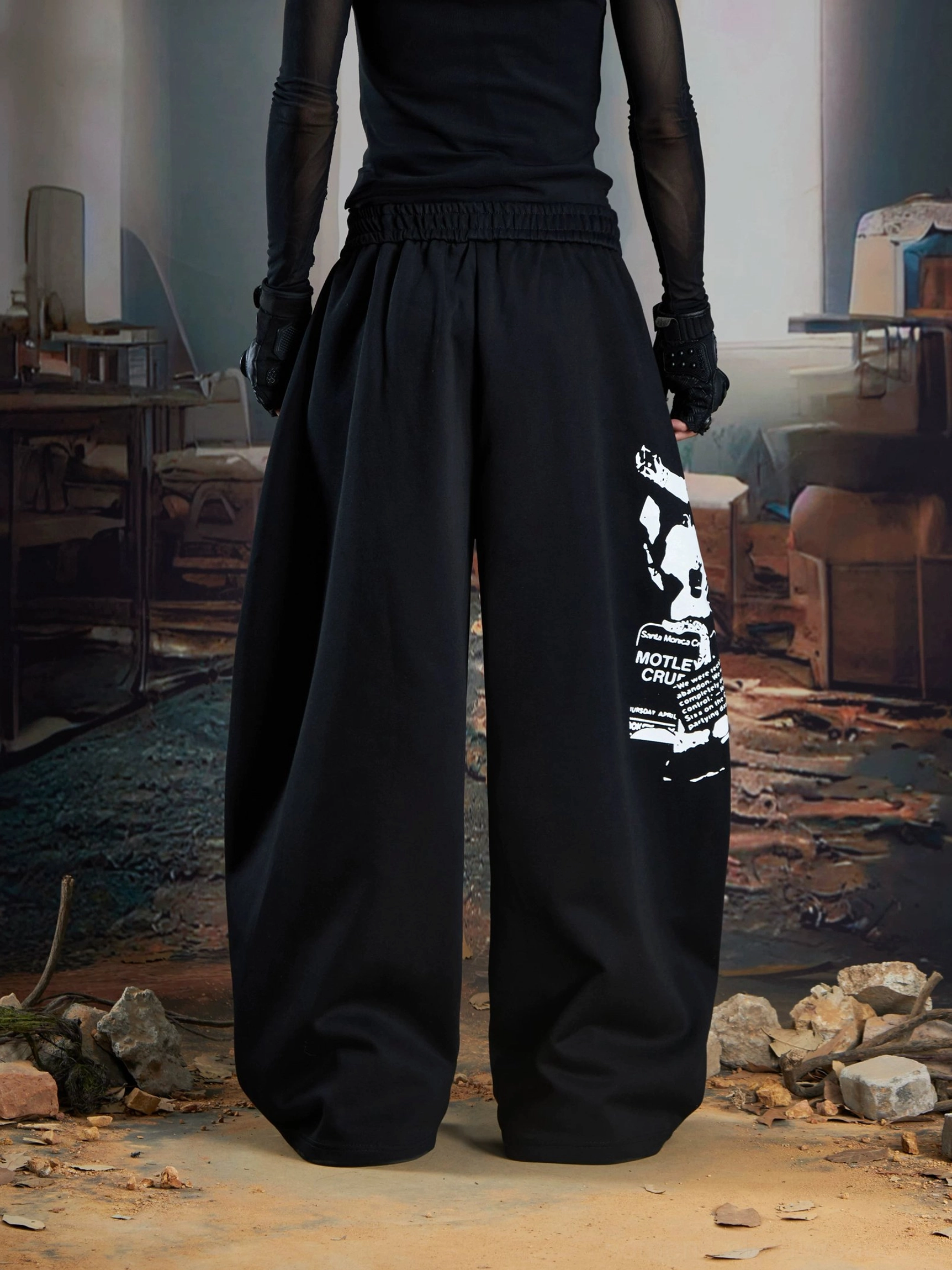 Black graphic wide-leg streetwear joggers back view showing elastic waistband and rear leg print