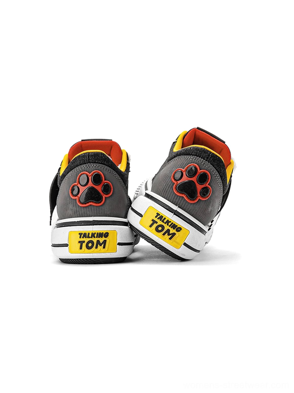 Rear view of black and gray low-top chunky sneakers featuring a contrast heel graphic, yellow heel label, and thick white outsole