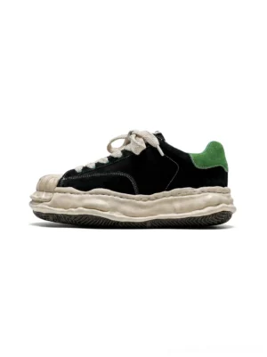 Black and green shell-toe platform sneakers with suede upper, cream chunky sole, and green heel tab shown in side product view