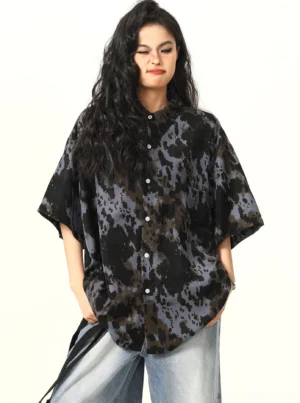 Three-quarter front view of black and grey abstract tie-dye oversized streetwear shirt with curved hem
