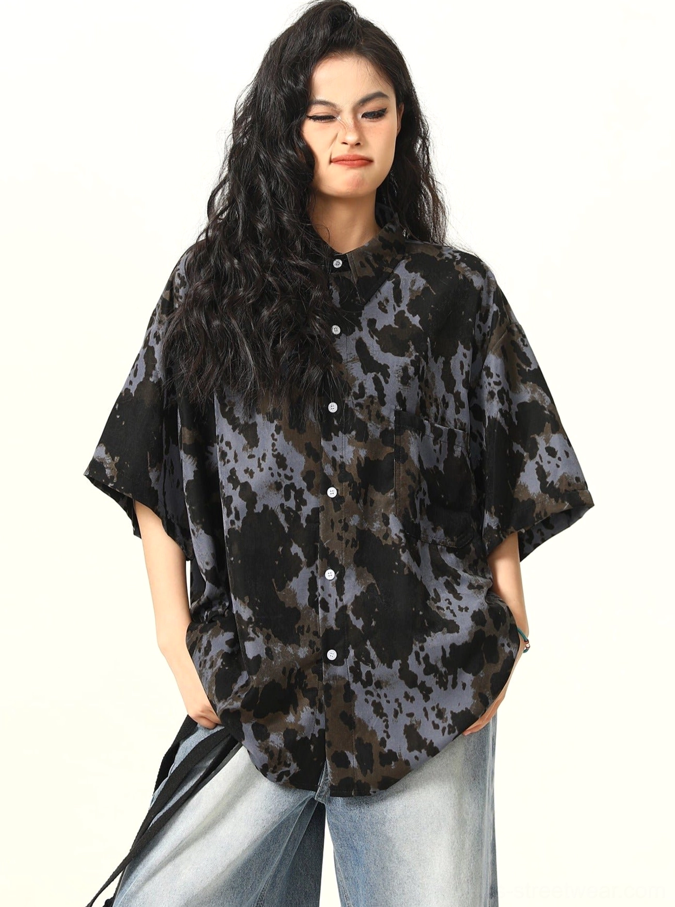 Three-quarter front view of black and grey abstract tie-dye oversized streetwear shirt with curved hem