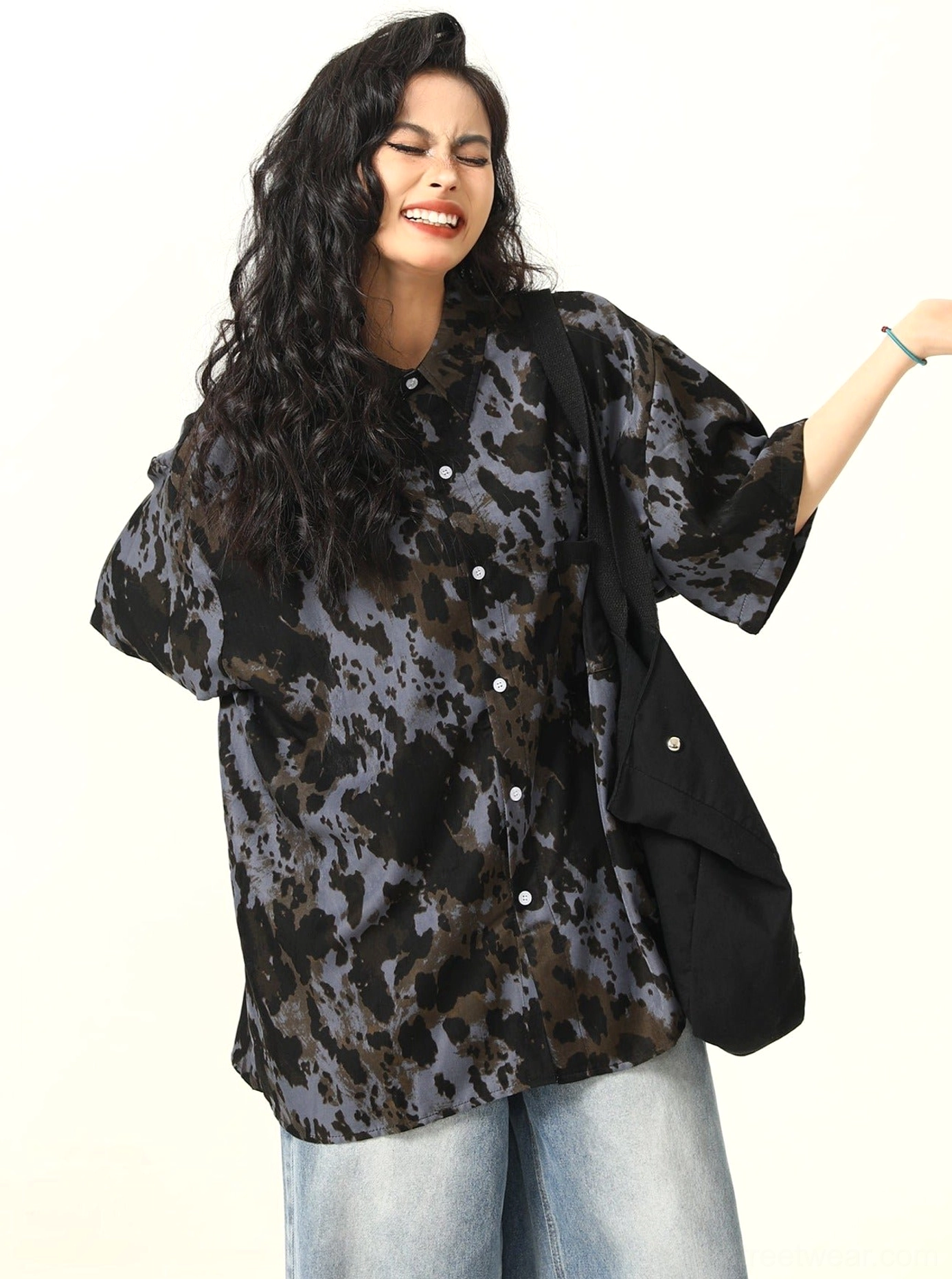 Back three-quarter view of black grey and brown abstract tie-dye oversized short-sleeve button-up shirt