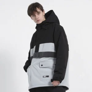 Male model wearing a black and light grey colorblock snow anorak with hood, half-zip closure, utility flap pockets, and relaxed gorpcore streetwear fit