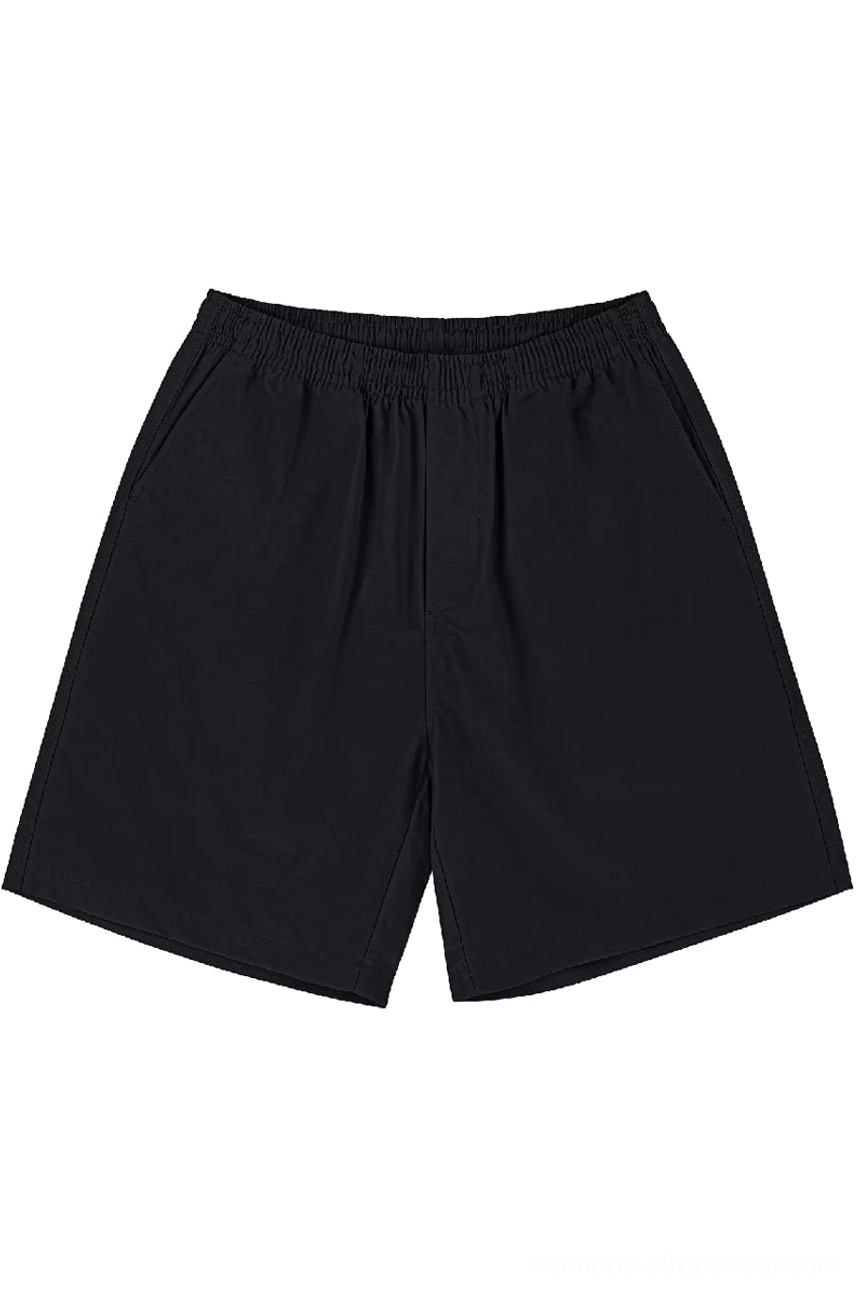 Black heavyweight cotton beach shorts with elastic waist and minimalist relaxed streetwear silhouette