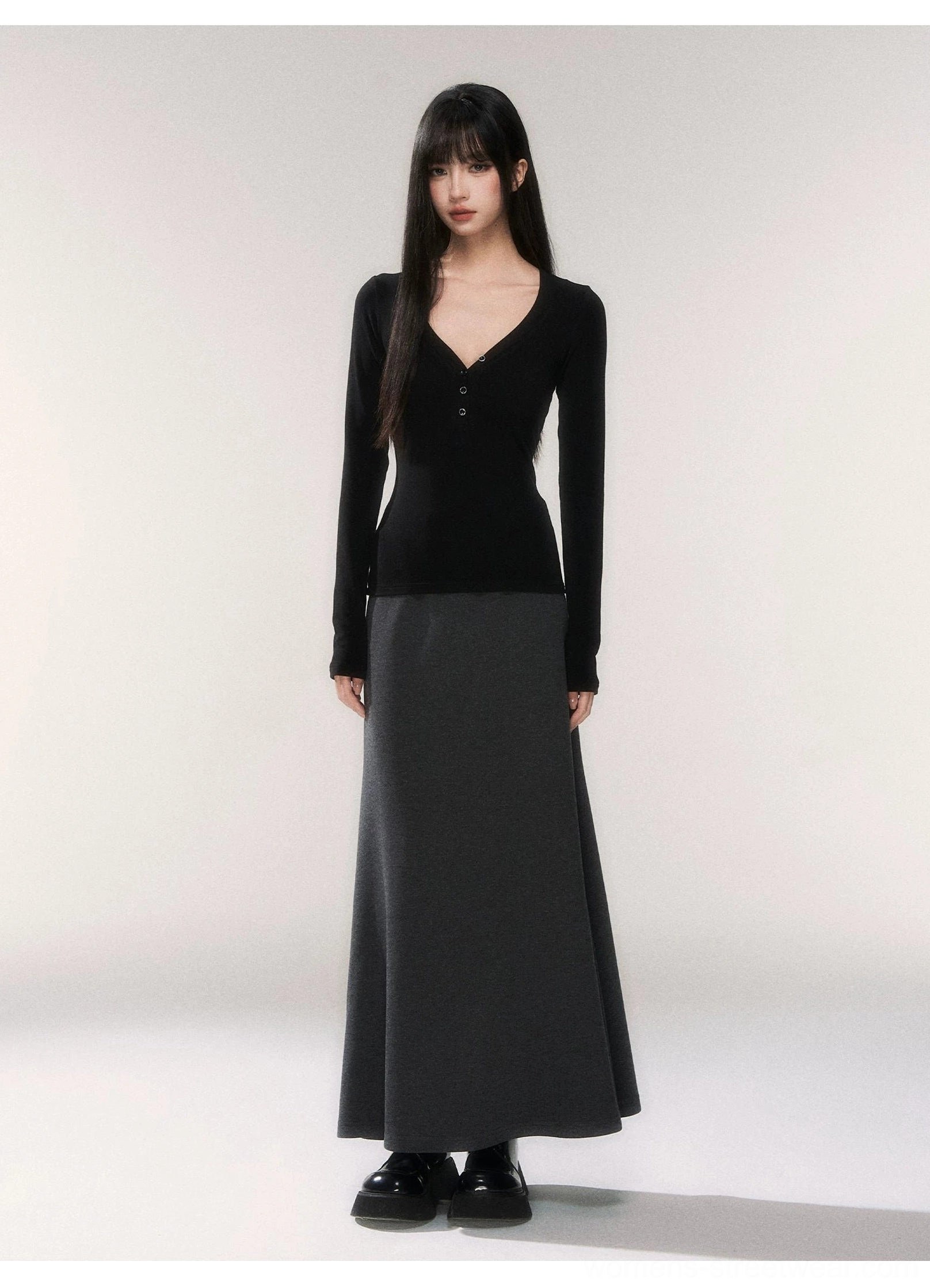 Fitted black henley long sleeve knit top paired with a flowing gray maxi skirt for a modern Seoul streetwear outfit
