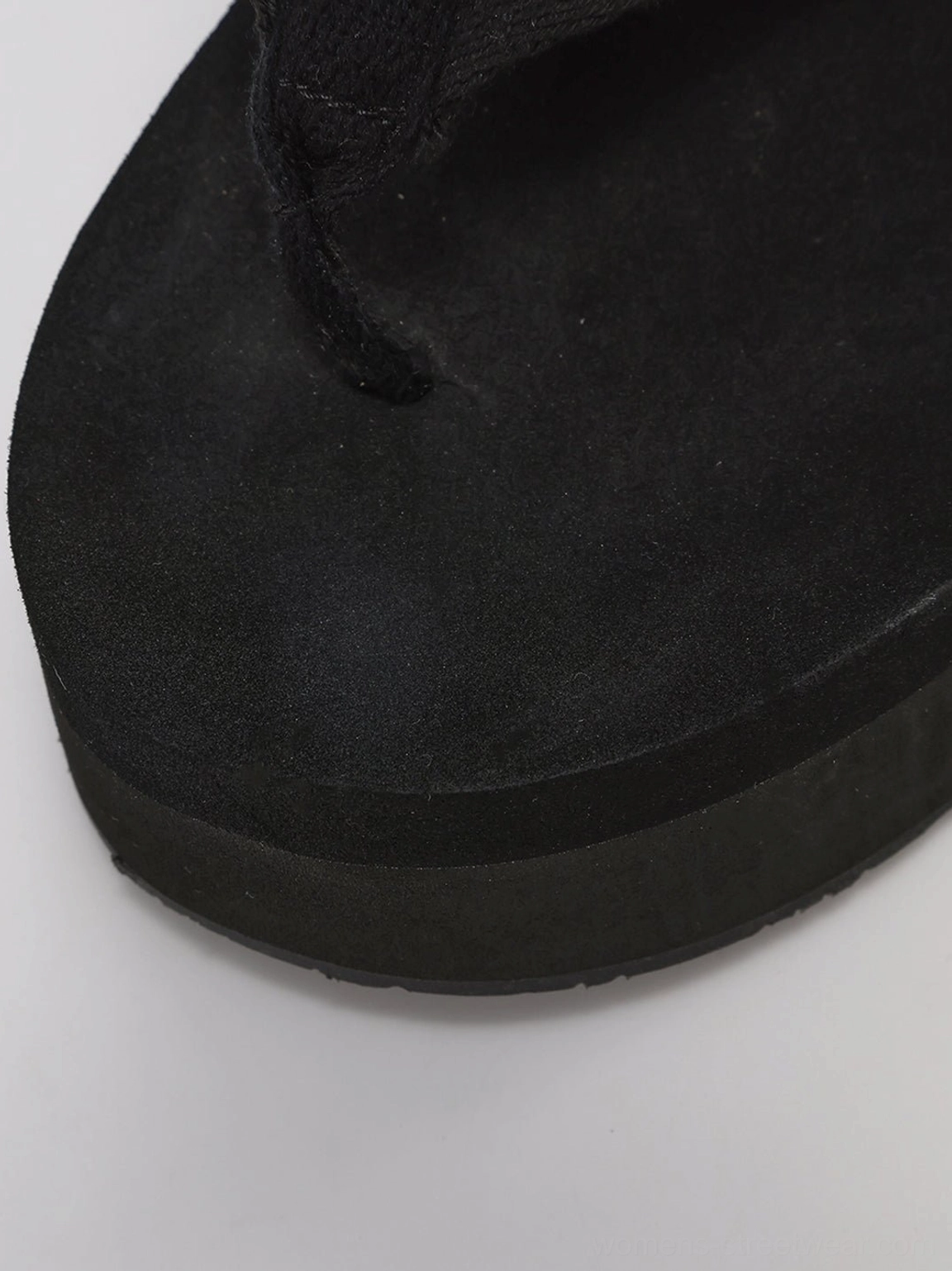 Detailed view of black hibiscus embroidered platform wedge flip-flops floral outer wedge artwork
