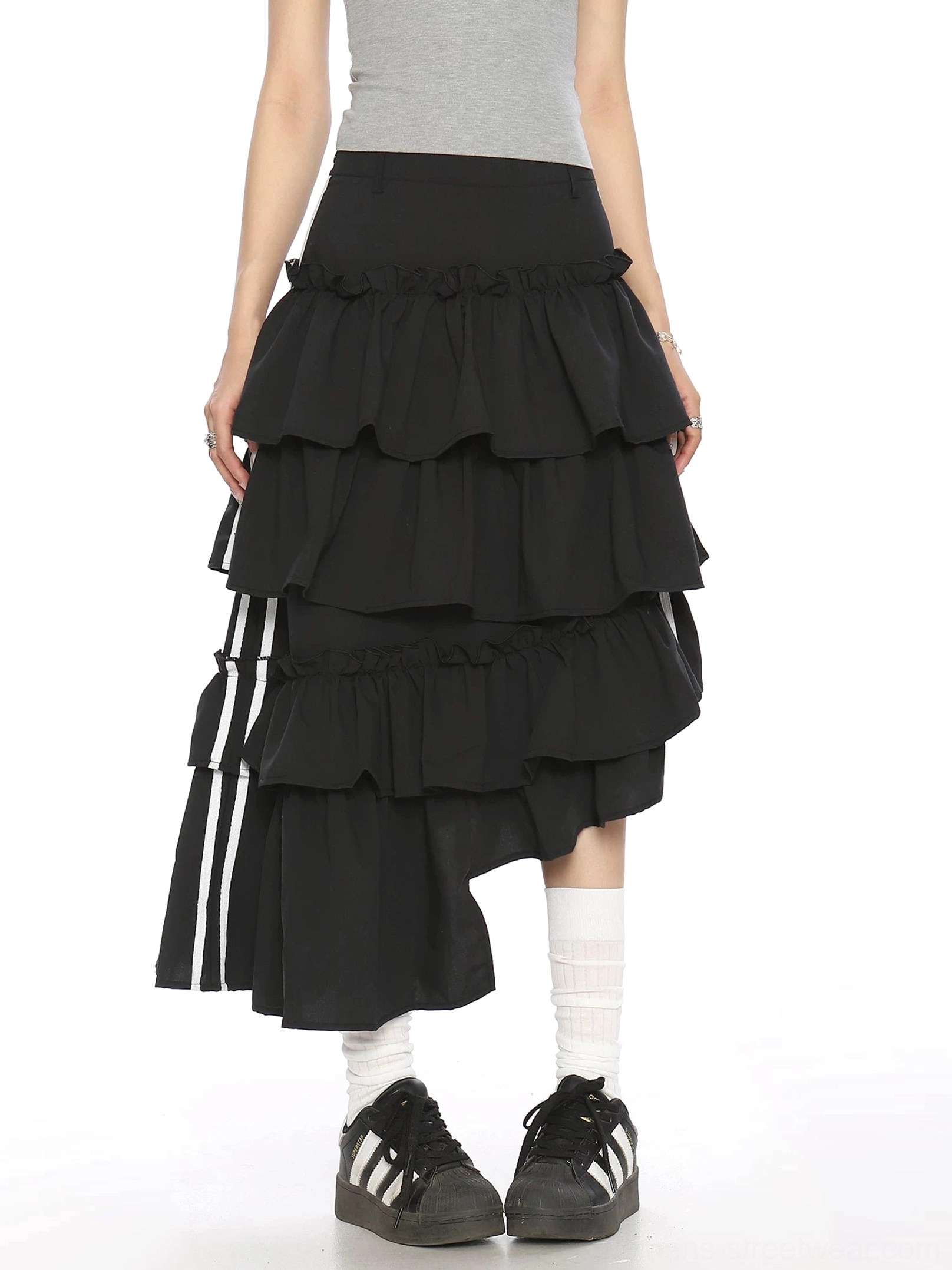 Front view of black high-low asymmetric tiered ruffle midi skirt with white striped side ribbon for womens streetwear