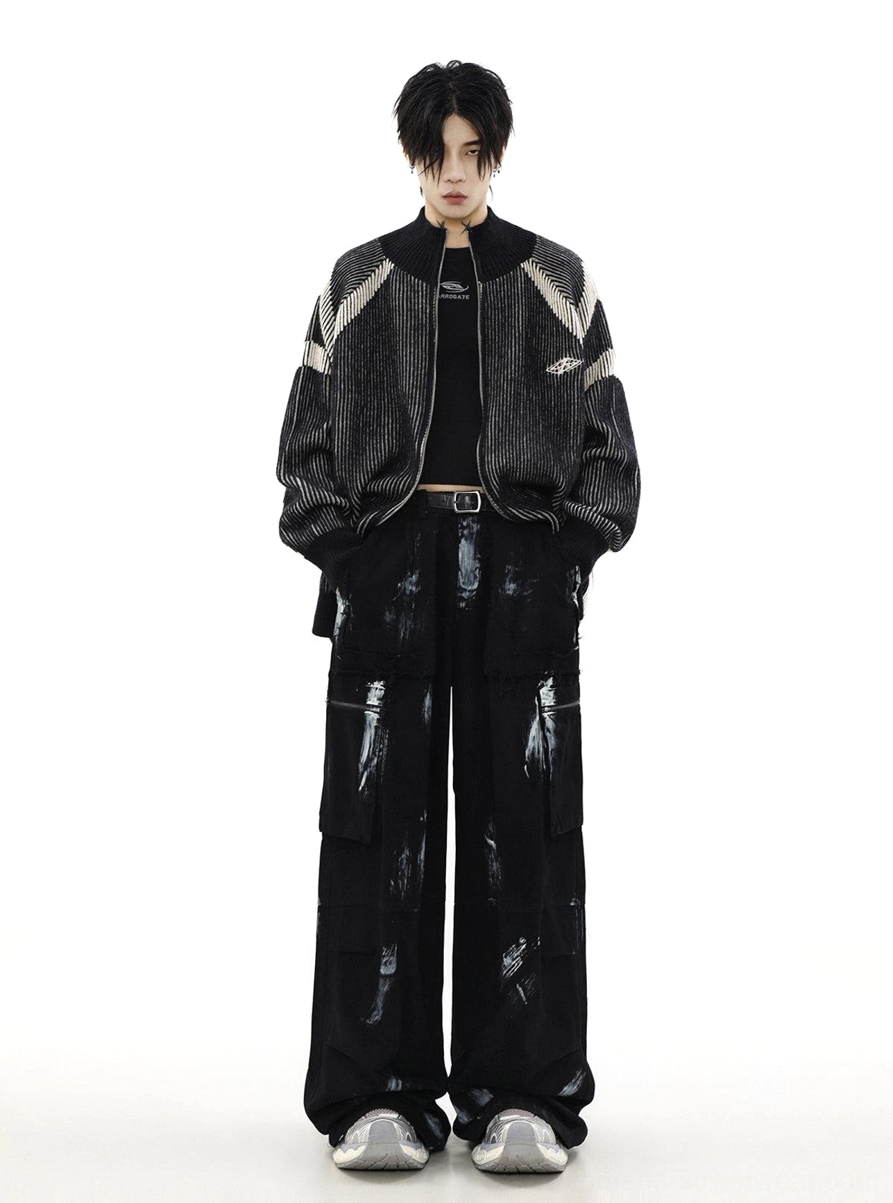 Black oversized high-neck zip cardigan styled with wide-leg cargo pants, ribbed knit texture, and contrast stripe details