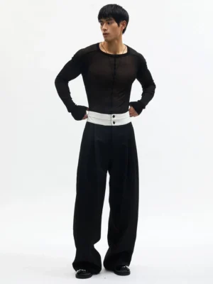 Black high-rise contrast waistband pleated wide-leg streetwear trousers shown in a full-body front view on an East Asian male model