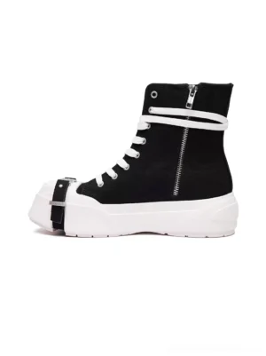 Black high-top platform sneakers shown from the front side with canvas upper, white laces, square toe buckle strap, side zipper, and bold white rubber platform sole
