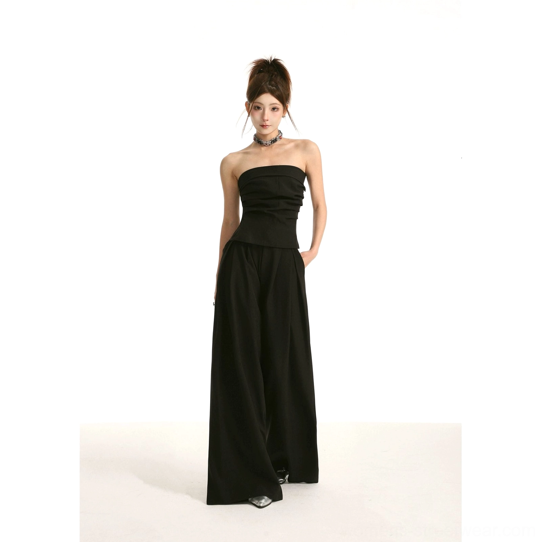 Black high-waist wide-leg streetwear trousers with front pleats and draped full-length silhouette