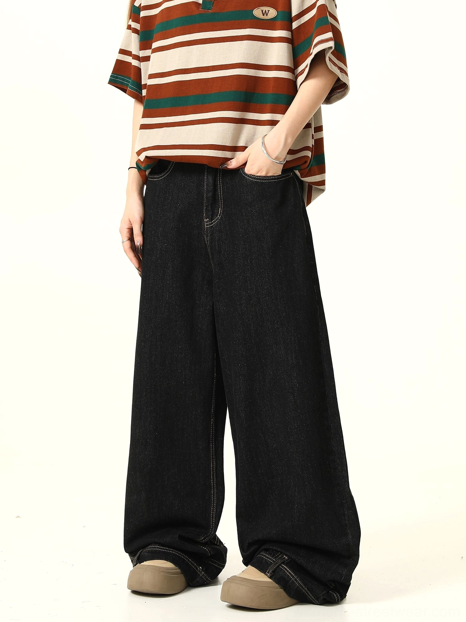 Three-quarter view of black high-waisted baggy wide-leg jeans with clean washed denim finish, relaxed fit, and casual streetwear styling