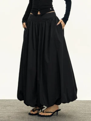 Black high waisted bubble maxi skirt front view with gathered waistband and voluminous balloon hem in studio