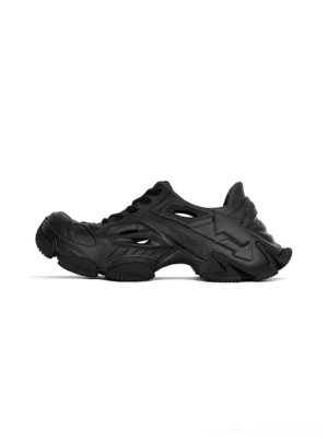 Black hollowed chunky clog sneakers shown in left side profile with matte finish, ventilation cut-out panels, lace-up upper, and exaggerated thick platform rubber outsole