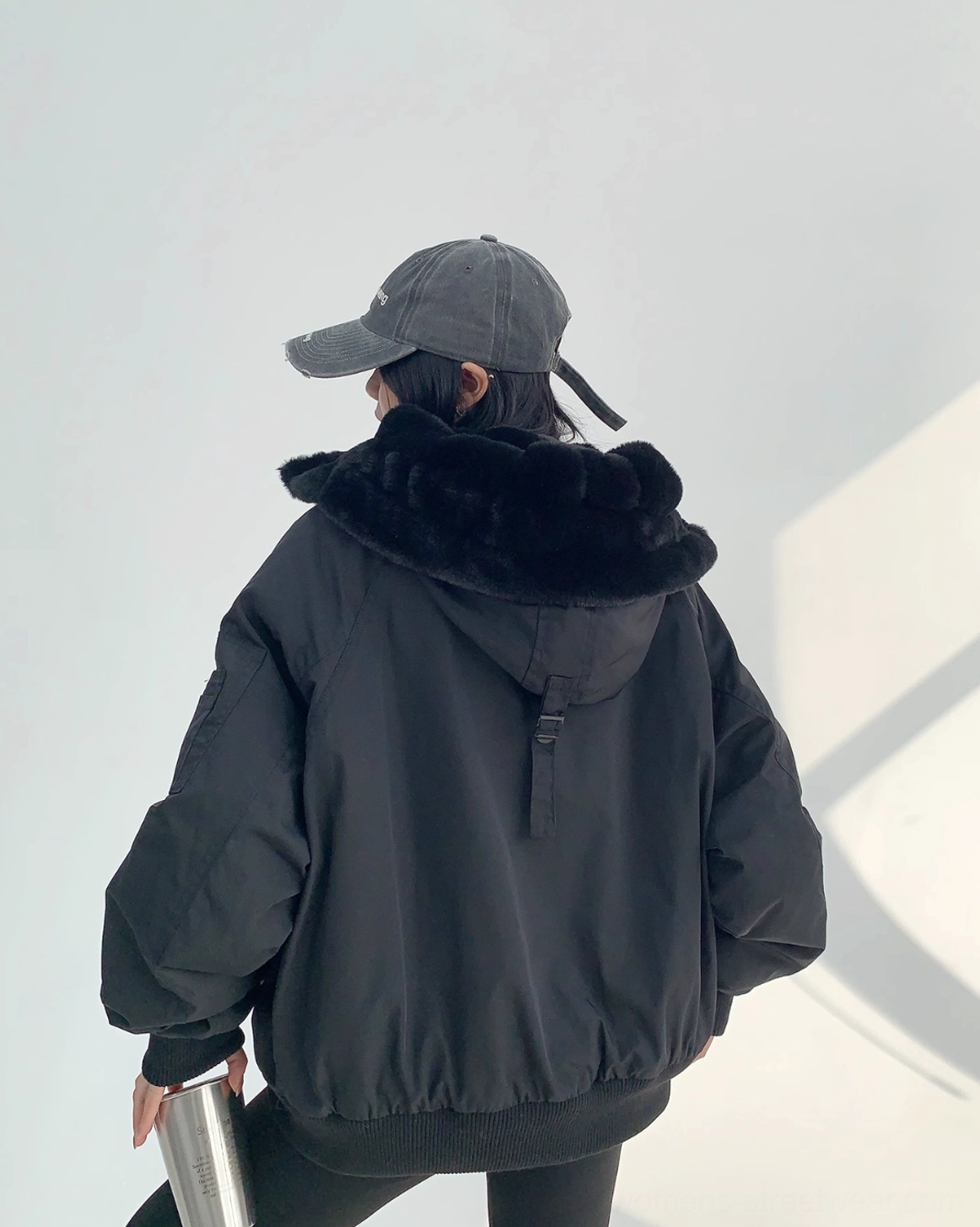 Black hooded aviator bomber jacket with cozy faux-shearling lining, oversized sleeves, and utility-inspired streetwear details