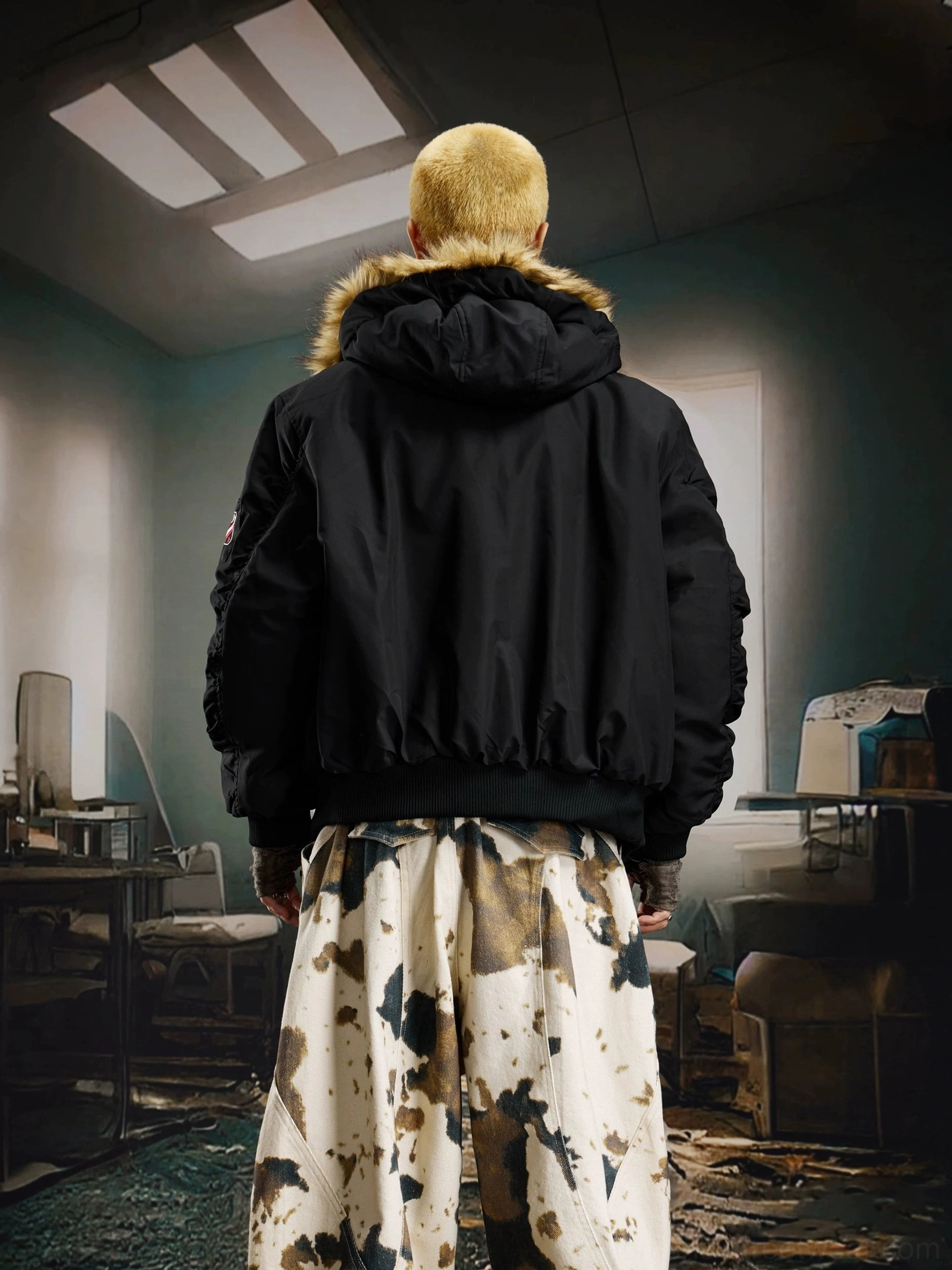 Rear view of a black cropped-inspired faux fur hooded bomber jacket showing its clean back silhouette with wide-leg pants